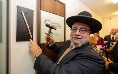 Chief Rabbi Pinchas Goldschmidt, the president of the Conference of European Rabbis, affixes a mezuzah to the doorframe of the Centre for Jewish Life in Munich, Germany on September 19, 2023.  Photo Credits: Rober Gongoll, CER