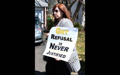 An orthodox woman protests against get refusal. (Courtesy)