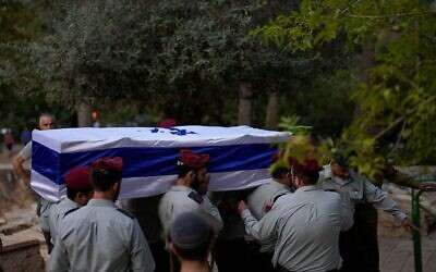 Israeli soldiers carry the flag-covered coffin of Maj. Tal Cohen during his funeral at the Givat Shaul cemetery in Jerusalem on Tuesday,