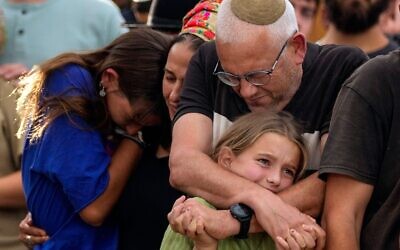 Family members mourn during the funeral of Israeli soldier Shilo Rauchberger at the Mount Herzl cemetery in Jerusalem.