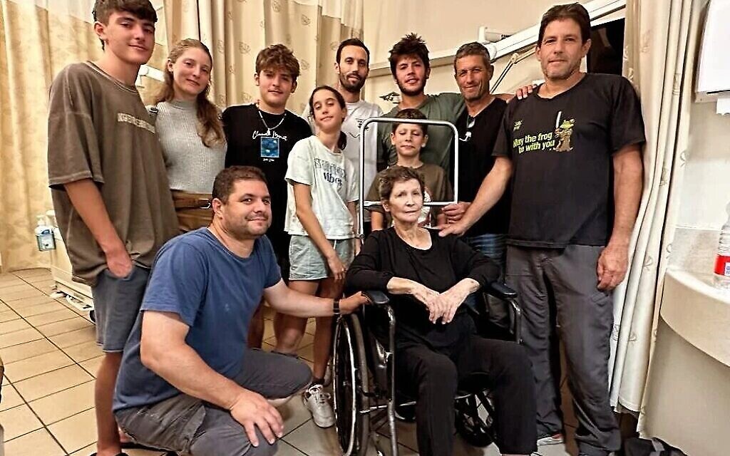 Yocheved Lifshitz (sitting) with her grandchildren at Ichilov Hospital following her release from Hamas captivity on October 23, 2023. (Courtesy)