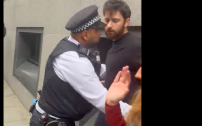 Anti-Zionist activist Barnaby Raine restrained by police