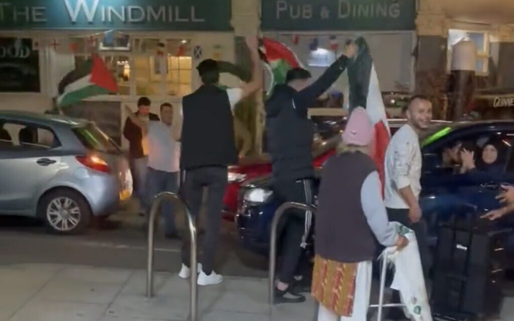 Action in west London on Saturday. Hamas supporters openly wave flags in the street in celebration.