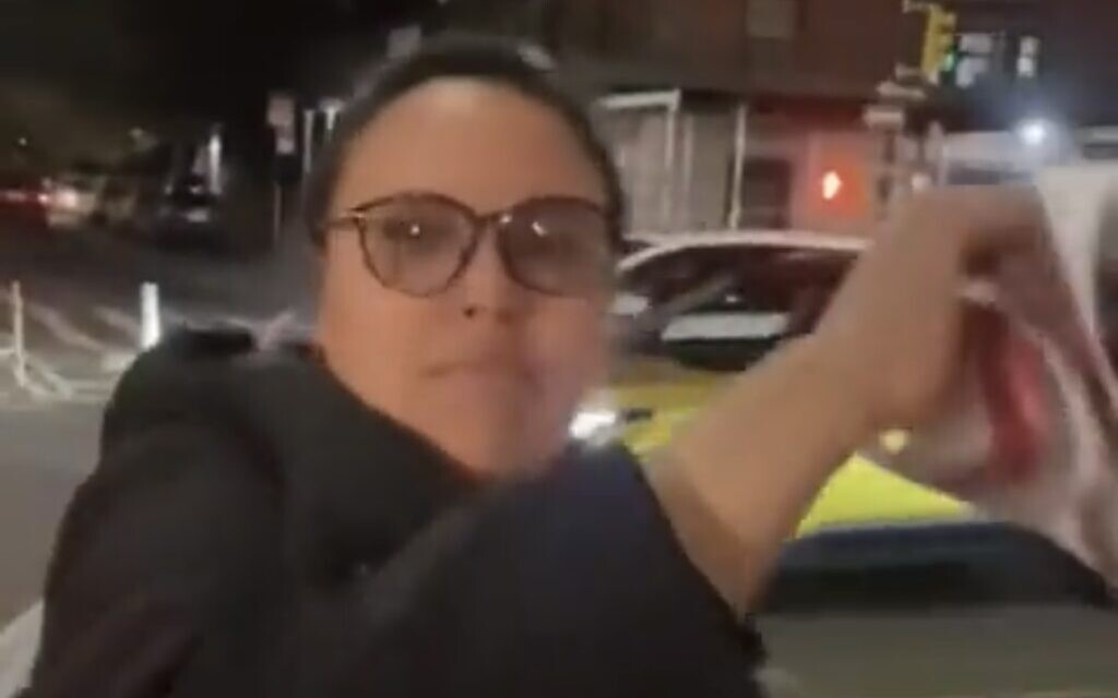 New York County public defender Victoria Ruiz ripping down kidnapped children posters.