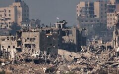 An Israeli flag atop a destroyed building in northern Gaza. An Israeli flag atop a destroyed building in northern Gaza.