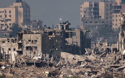 An Israeli flag atop a destroyed building in northern Gaza.