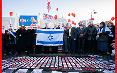 Deputy Prime Minister Oliver Dowden, Chief Rabbi Ephraim Mirvis and members of the Jewish community pose during a vigil at Keystone Passage in Borehamwood for victims and hostages of Hamas attacks.