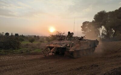 An Israeli armored personnel carrier return from the Gaza strip amid continuing battles between Israel and  Hamas on December 12, 2023 in Gaza border, Israel.