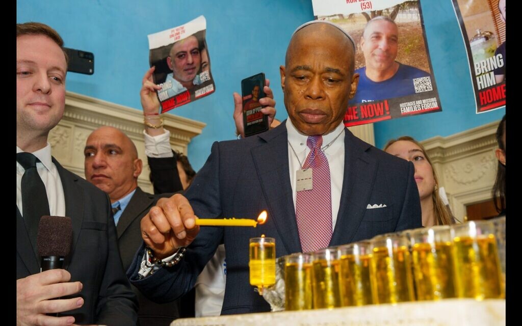 New York City Mayor Eric Adams lights the Hanukkah candles at a reception at Gracie Mansion on Tuesday, Dec. 12. (Benny Polatseck, Mayoral Photography Office)