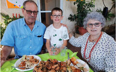 Ohad Munder, with his grandparents Ruthy and Avraham Munder. Avraham is still being held hostage in Gaza. 
Photo: Sharon Derhy and Michal Chitayat