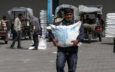 Palestinians receive aid packs from the United Nations Relief and Works Agency.