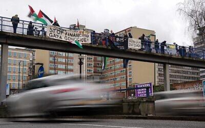 People taking part in a pro-Palestine protest on a bridge over the Queensway in central Birmingham.