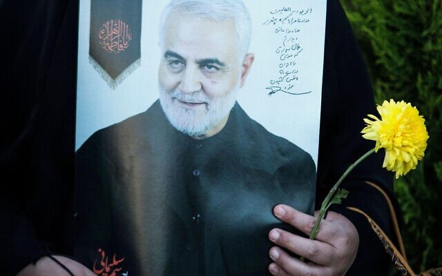 A woman holds a poster of Qassem Soleimani near his grave in Kerman, Iran, on Jan. 2, 2021.  Photo by /Xinhua IRAN-KERMAN-QASSEM SOLEIMANI-DEATH-ANNIVERSARY AhmadxHalabisaz PUBLICATIONxNOTxINxCHN