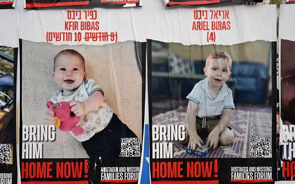 Campaign  posters of  Kfir Bibas, nine months and Ariel Bibas, four, who were kidnapped by Hamas and then murdered in Gaza.