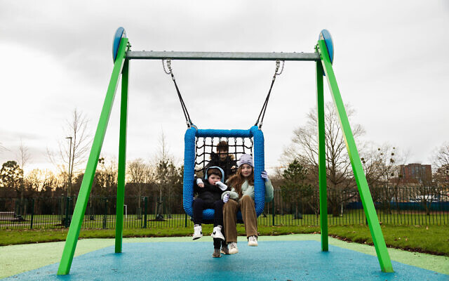 Children playing on an accessible swing. Pic: Chanelle Joseph.