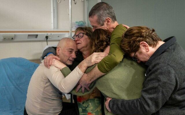 Louis Har (L) and Fernando Marman (2nd R) are reunited with loved ones at Sheba Medical Center, February 12, 2024 (Israel Defense Forces)