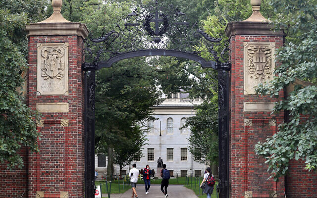 Students walk by the Harvard Yard gate in Cambridge, Massachusetts, Sep. 16, 2021. (David L. Ryan/The Boston Globe via Getty Images)