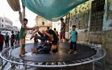Mosul, Nineveh, Iraq. 29th June, 2023. Iraqi children play at a mobile amusement park as they celebrate Eid al-Adha in the old city of Mosul northern Iraq. (Credit Image: © Ismael Adnan/SOPA Images via ZUMA Press Wire) EDITORIAL USAGE ONLY! Not for Commercial USAGE!