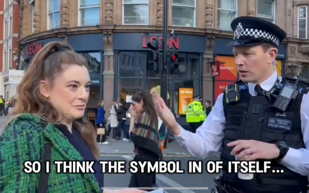 The officers claim "everything needs to be taken in context" despite the obscene Nazi symbol being paraded the pro-Palestine march.