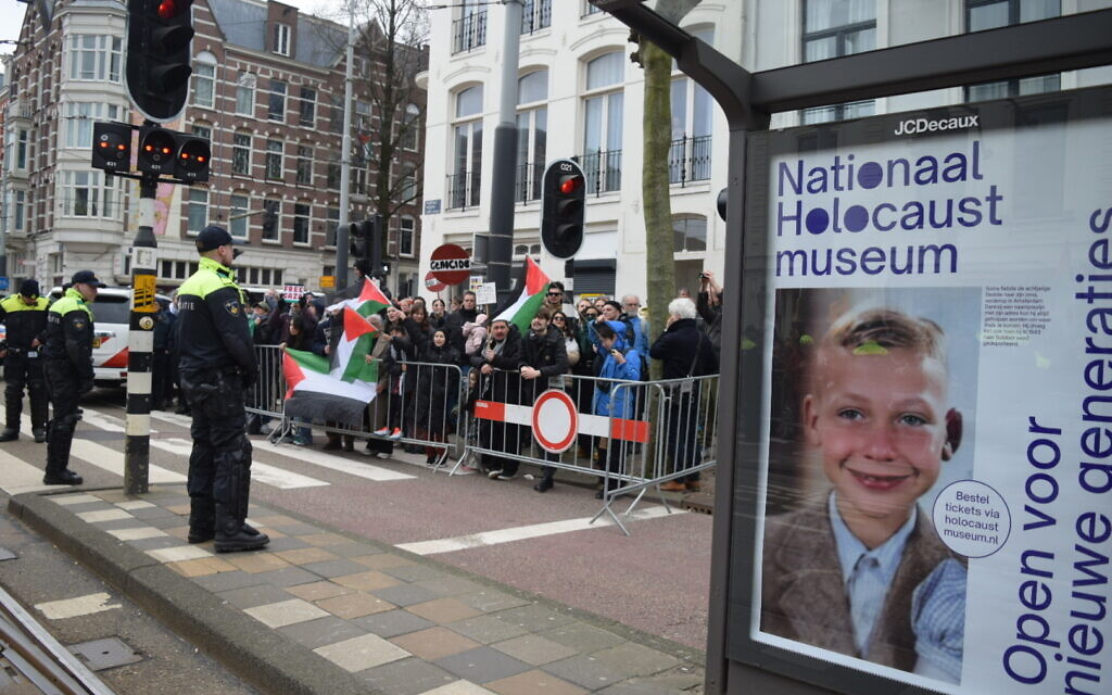 Pro-Palestinian protesters hold flags during a rally outside the opening of the National Holocaust Museum in Amsterdam, Netherlands, on March 10, 2024. (Mouneb Taim /Anadolu via Getty Images) JTA