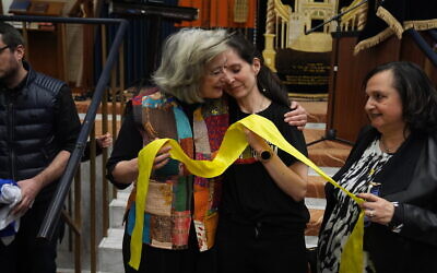 Maureen Lipman (left) and Nivi Feldman hold a yellow ribbon used as a symbol to demonstrate support for the hostages taken in the October 7 Hamas attacks, during a rally calling for their release at St Johns Wood United Synagogue