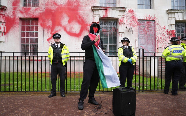 Police officers at the Ministry of Defence in London, after members of Youth Demand threw red paint over the outside of the building. Picture date: Wednesday April 10, 2024. PA Photo. See PA story POLITICS Protest. Photo credit should read: Lucy North/PA Wire