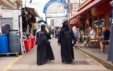 Muslim women walking through Shepherds Bush Market in west London.