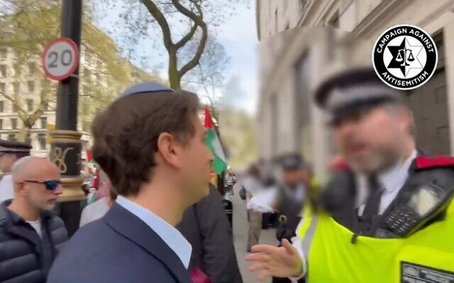 Gideon Falter and police officer exchange words at April 13 demo