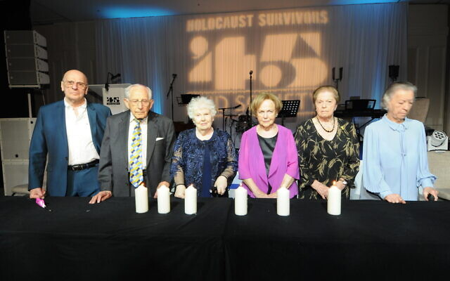 (l-r: Jackie Young, Harry Olmer, Joanna Millan, Mala Tribich Rachel Levy and Zdenka Husserl, plus members of the 3nd generation), lighting 6 memorial candles to represent the 6 million Jewish lives tragically lost during the Holocaust. 45 Aid 2024 Dinner 13486 Photo John Rifkin