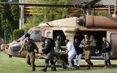 Israeli army rescue medics and a hospital worker stretcher a wounded Israeli soldier from a helicopter. Israeli army rescue medics and a hospital worker stretcher a wounded Israeli soldier from a helicopter.