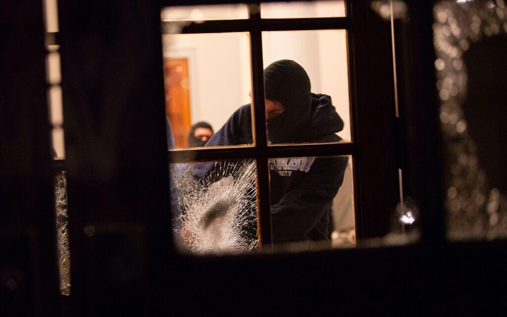 Students with the Gaza Solidarity Encampment break the doors to the entrance of Hamilton Hall at Columbia University after taking over on Tuesday, April 30.