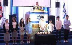 Chazan Avromi Freilich says the azkara, memorial prayer, after HGSS youth light memorial candles. Yom Hazikaron, May 2024. Pic: Bernard Fromson Chazan Avromi Freilich says the azkara, memorial prayer, after HGSS youth light memorial candles. Yom Hazikaron, May 2024. Pic: Bernard Fromson