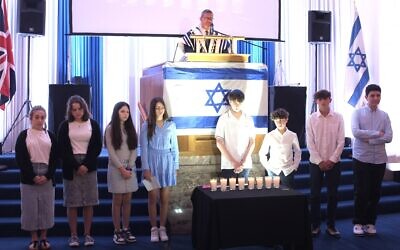 Chazan Avromi Freilich says the azkara, memorial prayer, after HGSS youth light memorial candles. Yom Hazikaron, May 2024. Pic: Bernard Fromson