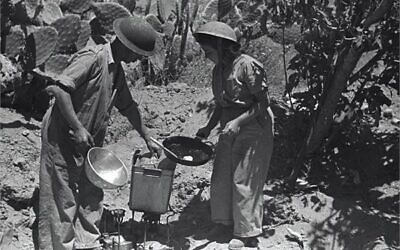 A female soldier is preparing lunch for fighters on the front lines near Lod-Ramla, 1948. Photo by Fred Chesnik, KKL-JNF Photo Archive