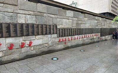 Holocaust memorial in Paris, vandalised with blood-red hands. Courtesy: X