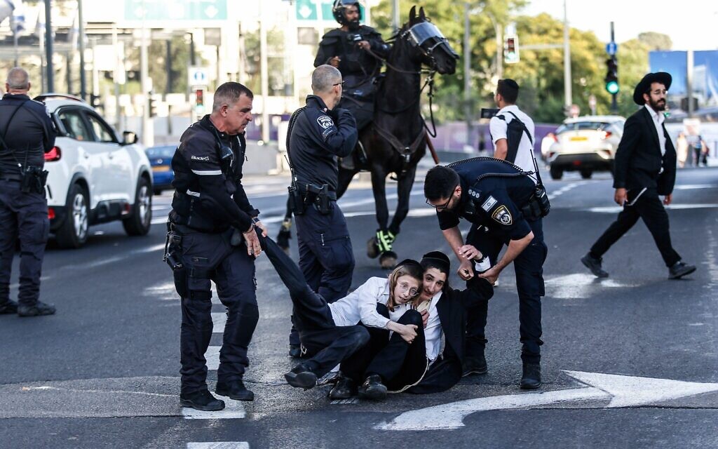 Police officers remove ultra-Orthodox Jews blocking the road during a protest against military conscription outside the Israeli Supreme Court. Israel's Supreme Court hears on 02 June a response by the state over the ultra orthodox recruitment issue, after previously extending a deadline for the government to present a conscription plan for ultra-Orthodox Jews, who are traditionally exempt from military service. (Credit Image: © Saeed Qaq/SOPA Images via ZUMA Press Wire) EDITORIAL USAGE ONLY! Not for Commercial USAGE!