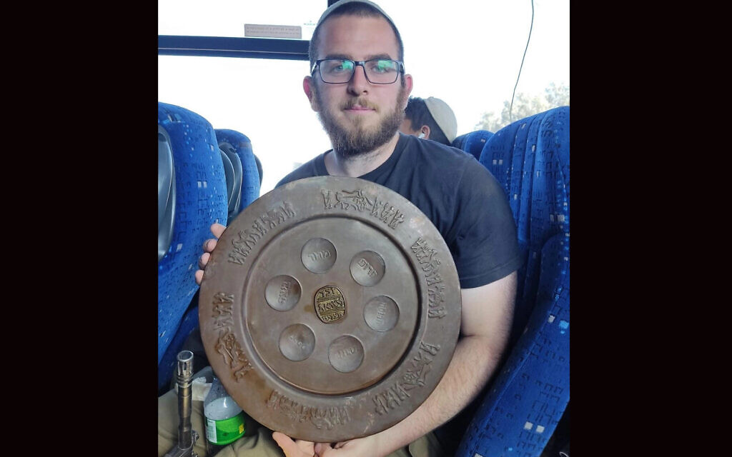 Or, a solider fighting in Gaza, displays a seder plate he found in the territory. (Courtesy of Or)