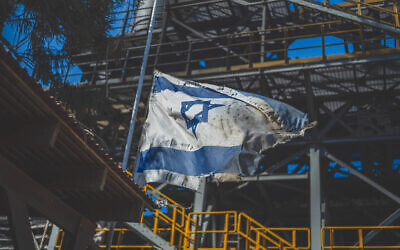 A view of a ripped Israeli flag following the deadly attack by Islamist Hamas militants on Kibbutz Nir Oz, Oct. 19, 2023. (Ilia Yefimovich/picture alliance via Getty Images)