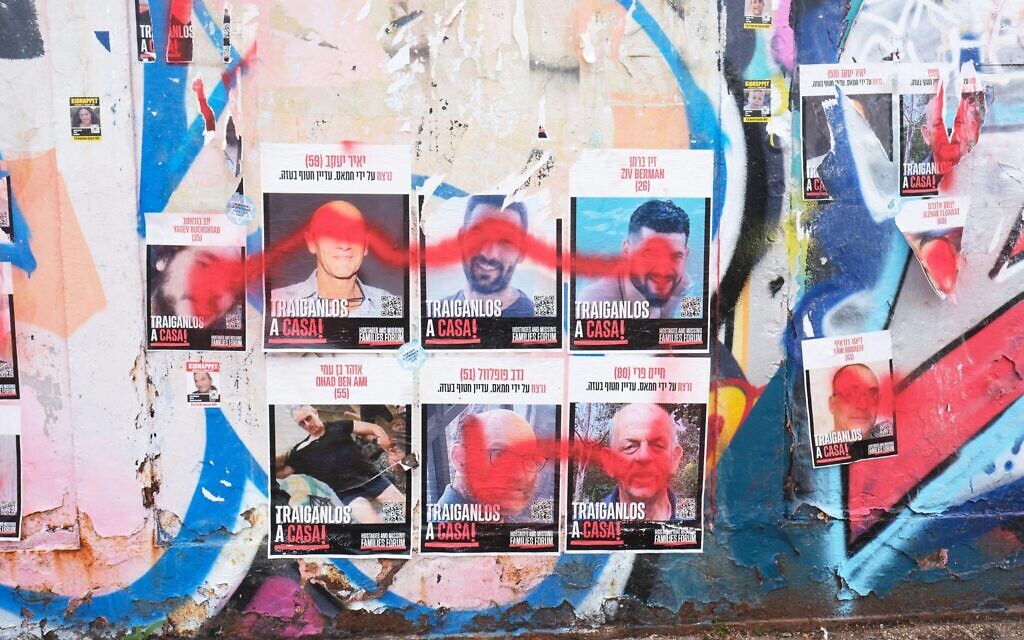 Defaced posters showing some of the Israeli hostages in the Primrose Hill area of north London