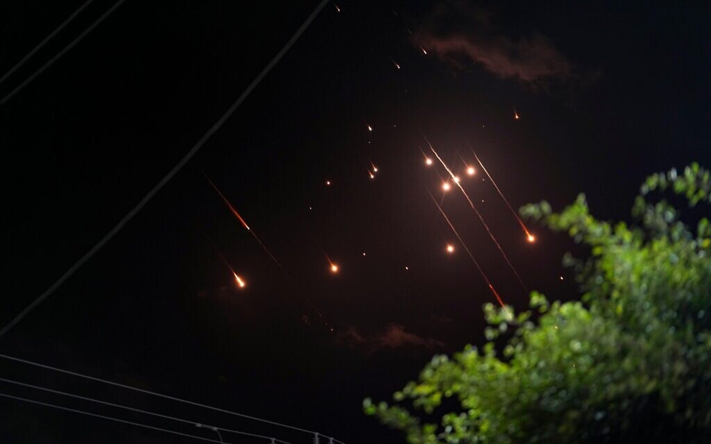 Missiles launched from Iran towards Israel streak across the night sky as seen from Deir al-Balah, Gaza Strip, Tuesday, Oct. 1, 2024. (AP Photo/Abdel Kareem Hana)