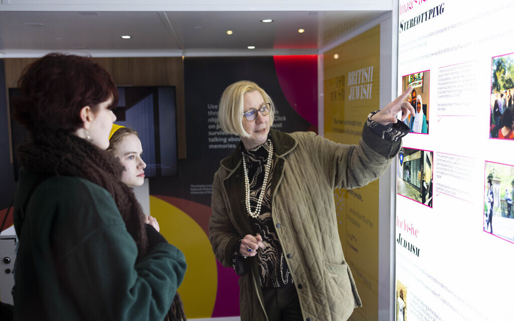 Professor Maiken Umbach, right, explains part of the National Holocaust Museum's touring exhibition 'I SAY BRITISH, YOU SAY JEWISH' outside Hampstead Theatre, London. Photo David Parry