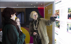 Professor Maiken Umbach, right, explains part of the National Holocaust Museum's touring exhibition 'I SAY BRITISH, YOU SAY JEWISH' outside Hampstead Theatre, London. Photo David Parry