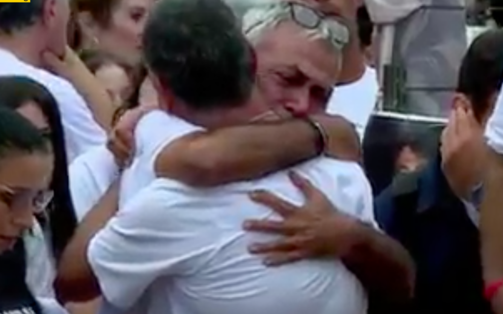 Hostage families hug at anniversary commemoration of Oct 7 (pic Sky News)
