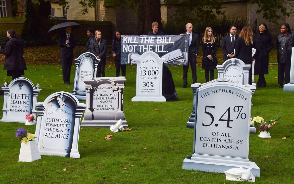 Protesters against the Assisted Dying BIll mourn in a mock graveyard to highlight the bill’s dangers. Photograph: Vuk Valcic/Alamy Live News