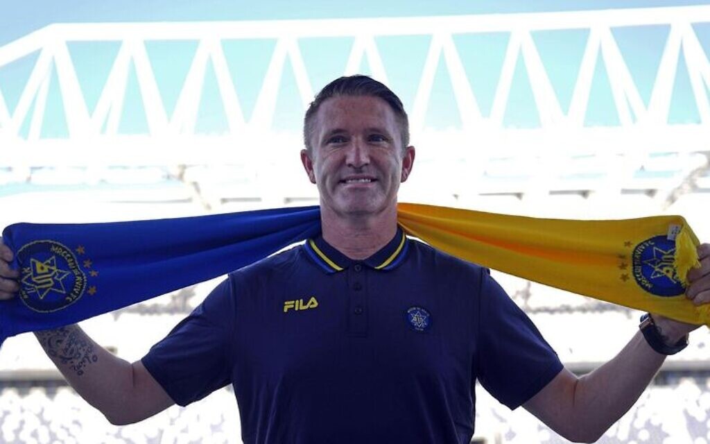 Former Ireland soccer great Robbie Keane poses for photographers in Tel Aviv, Israel, Tuesday, June 27, 2023.