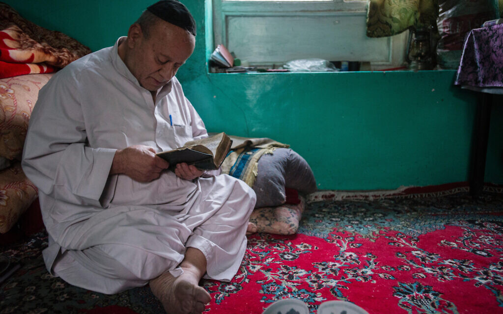 Zabolon Simantov, the last Afghan Jew, prays before eating in his room in the same building as synagogue, where he lived and called "home", Kabul, Afghanistan