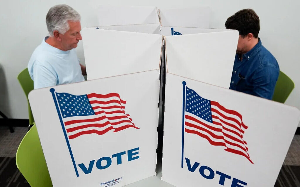 People mark their ballots at a polling location in Falls Church, Virginia, on October 31, 2024. Stephanie Scarbrough/AP