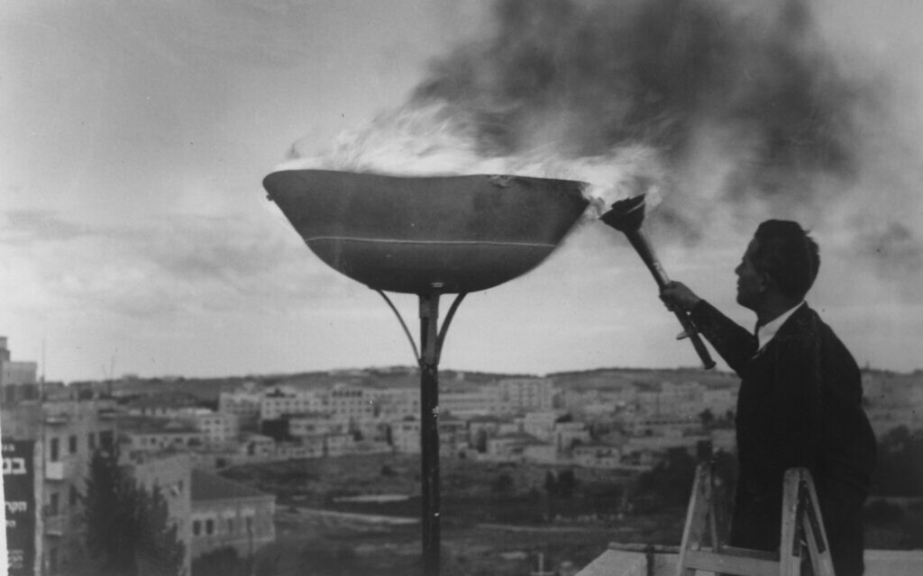 Lighting of a torch brought from Modi'in in a race commemorating the Maccabees, on the roof of KKL-JNF's main office in the National Institutions building. Credit - KKL-JNF Photo Archive Lighting of a torch brought from Modi'in in a race commemorating the Maccabees, on the roof of KKL-JNF's main office in the National Institutions building. Credit - KKL-JNF Photo Archive