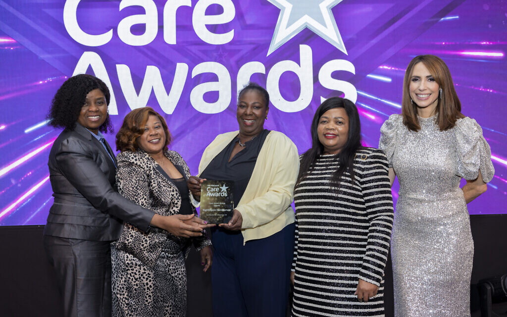 Team collecting National Care Awards 2024 trophy