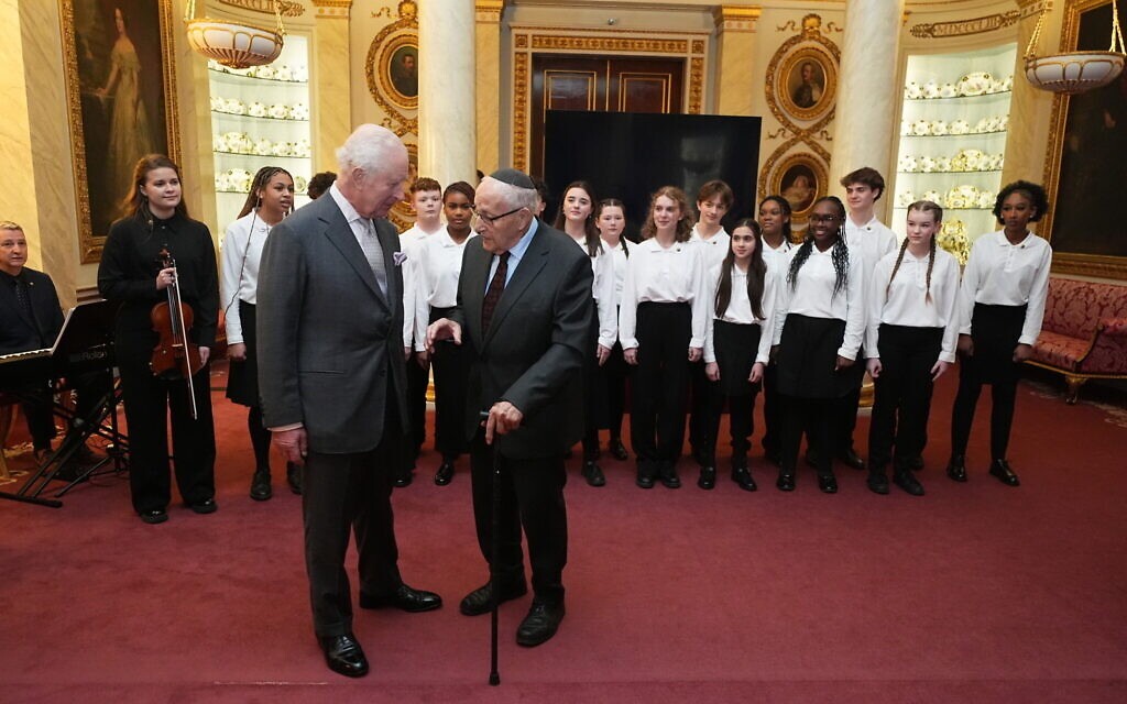 King Charles III speaks to Holocaust survivor Manfred Goldberg during a reception marking Holocaust Memorial Day at Buckingham Palace in London.